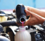 Mechanic refilling coolant for vehicle cooling system repair at TAAS